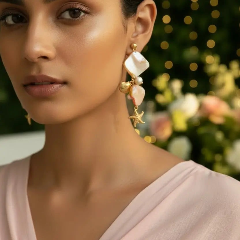 Close up Gold plated scallop starfish drop earrings on model — party wear  statement earrings for women India