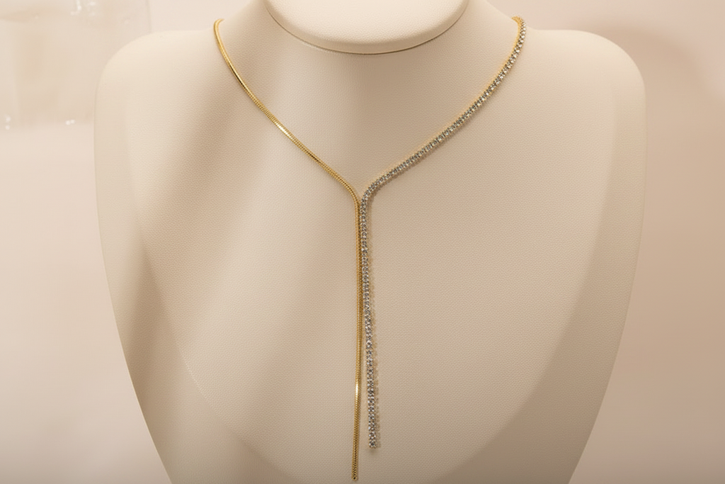 Gold plated tennis snake chain tassel necklace flat lay — Oneofé luxury jewellery