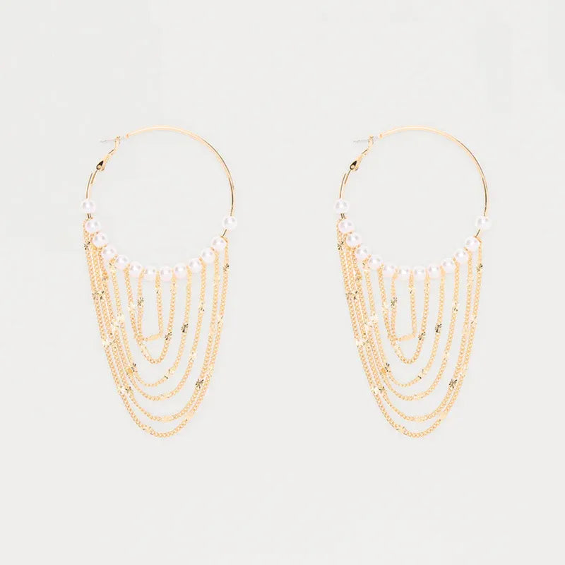 Gold-tone freshwater pearl hoops with graduated chain tassels on white – festive statement earrings for women – Oneofé