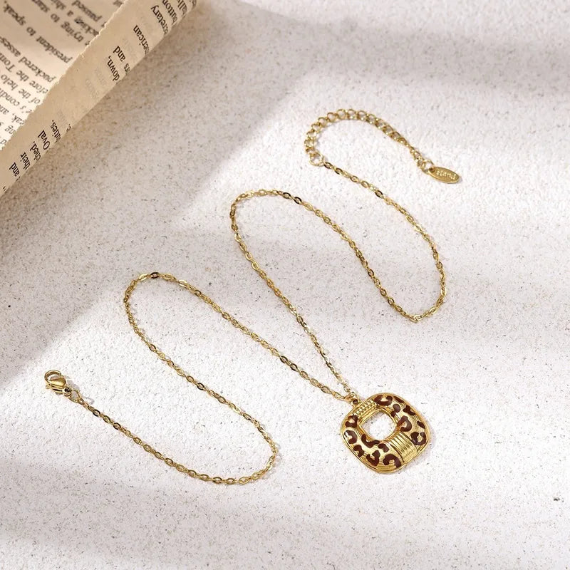 18K gold plated hollow square leopard print pendant on delicate gold link chain flat lay – statement necklace women India – Oneofé