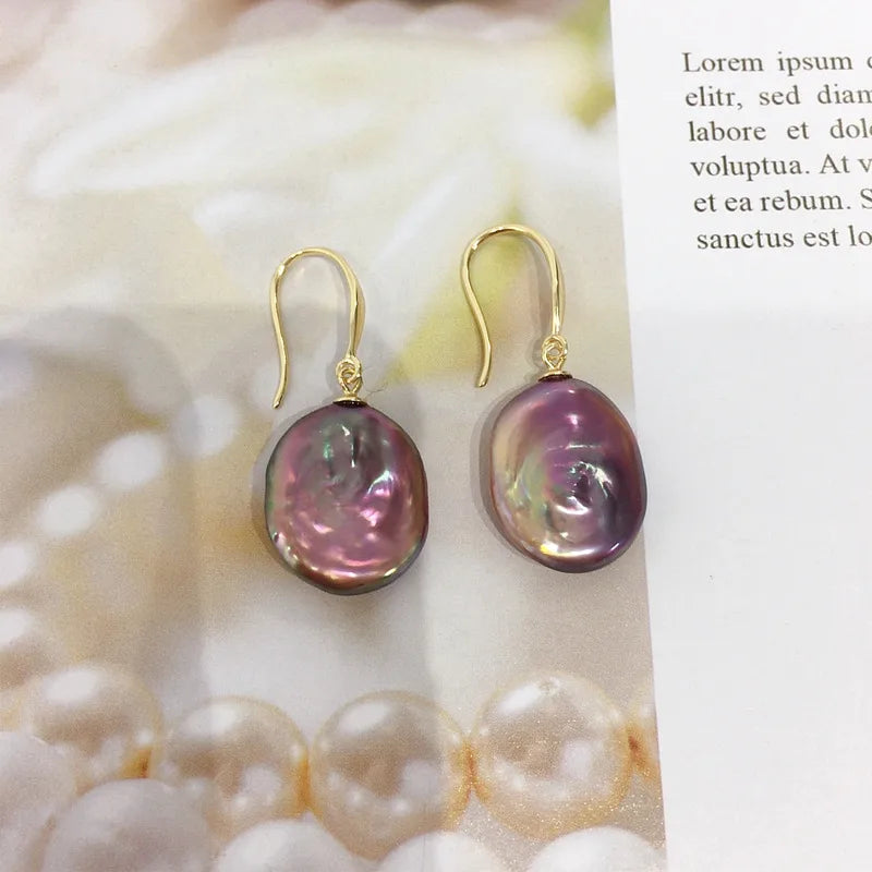  Gold plated copper purple baroque pearl drop earrings on a pearlescent backdrop – festive jewellery for women – Oneofé