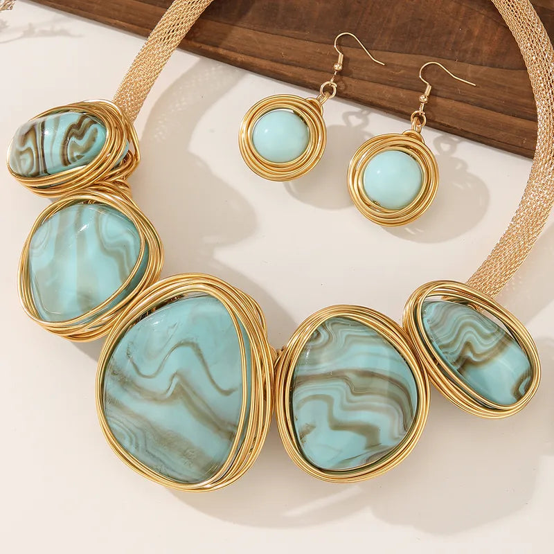 Turquoise blue marbled resin necklace and round earrings with gold-tone wire frames – statement jewellery for women – Oneofé