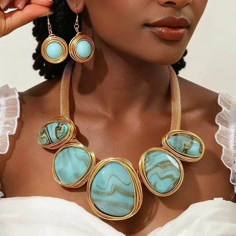 Turquoise blue oval resin statement necklace with gold-tone chain, styled with a white top – jewellery for women – Oneofé