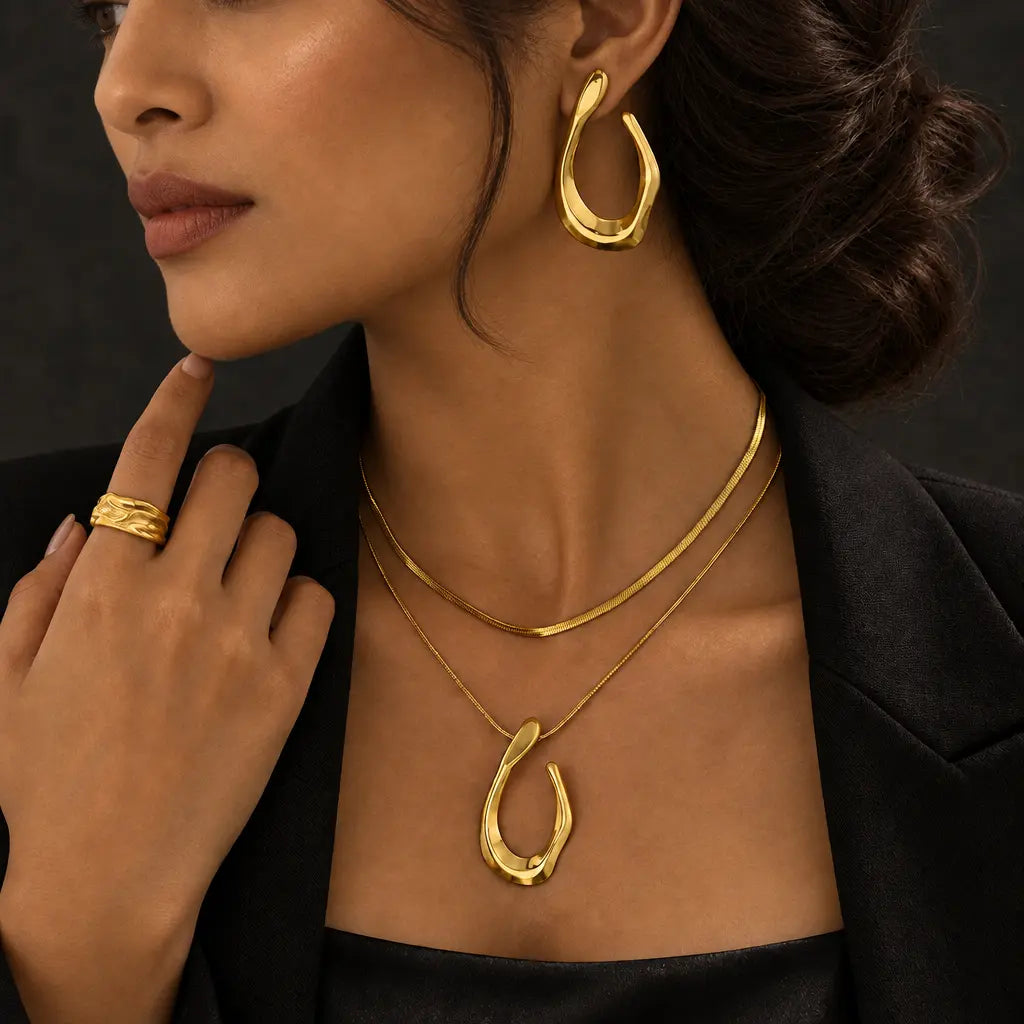 Gold-tone stainless steel teardrop jewellery with a black blazer – evening statement styling for women – Oneofé