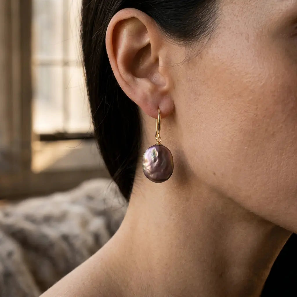 Gold plated copper purple baroque pearl drop earring close-up on a model – statement jewellery for women – Oneofé