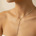 Gold plated tennis snake chain tassel necklace flat lay — Oneofé luxury jewellery